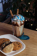 Coffee cocktail with whipped cream and blue topping.