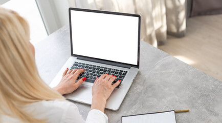 Rear view of business woman hands busy using laptop at office desk, with copyspace