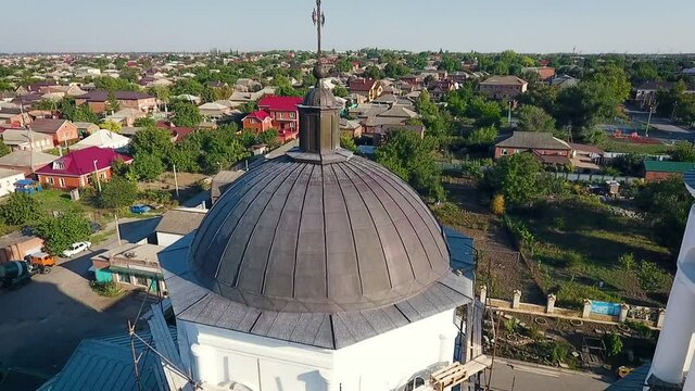 Aerial view of a christian cathedral with bell tower and domes.