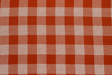 Textile background with checkered red tablecloth, top view. Texture of natural linen fabric.