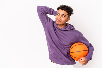 Young african american curly man isolated playing basketball touching back of head, thinking and making a choice.