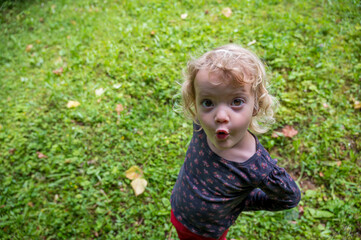 Drop down portrait of cute girl making faces.
