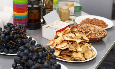 Buffet table with a treat of herbal tea, dried fruit, nuts and honey