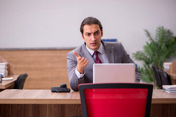 Young businessman employee in bullying concept in the office