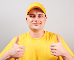 Portrait satisfied, affable guy in a yellow t-shirt and cap