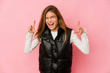 Young skinny caucasian teenager girl showing claws imitating a cat, aggressive gesture.