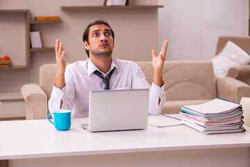 Young male employee working from home during pandemic