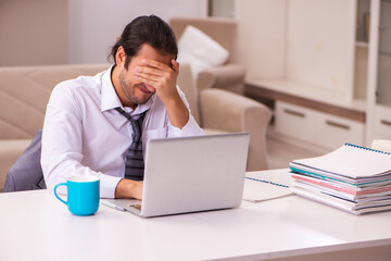 Young male employee working from home during pandemic