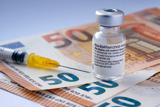 Genuine Pfizer BioNTech COVID-19 Vaccine Vial Placed On Euro Banknotes. Real Vaccine Photo. Selective Focus. Stafford, United Kingdom - January 23 2021.