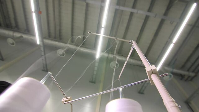 Contemporary sewing machine with coils of white threads