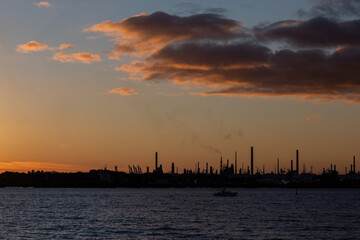 Naklejka premium Fawley oil refinery Hampshire, England at dusk. Oil refinery energy production fossil fuels pollution environmental impact