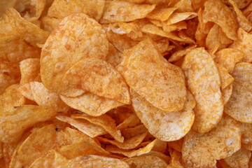 Potato chips or crisps . Close-up of potato chips or crisps. Food background.