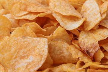 Potato chips or crisps . Close-up of potato chips or crisps. Food background.