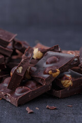 Chocolate cupcake with icing and chocolate bar in Dark lighting,Homemade delicious chocolate muffin on wooden background close-up