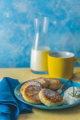 Cottage cheese pancakes, syrniki, ricotta fritters on ceramic plate. Gourmet healthy delicious morning breakfast. Copy space