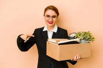 Young skinny arab business woman moving job isolated person pointing by hand to a shirt copy space, proud and confident