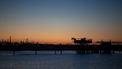 
Oil refinery at dusk. Oil refinery energy production fossil fuels pollution environmental impact