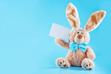 Blue background with toy bunny for Easter