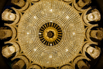 A view from the bottom up to a symmetrical beautiful chandelier.