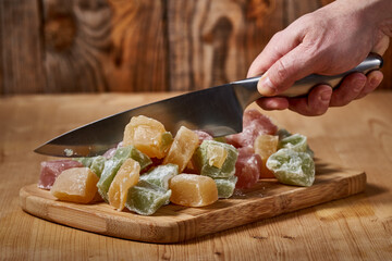 Knife and Turkish delight on a wooden board