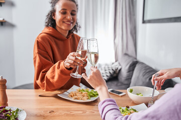 Friends celebrating and toasting with wine during dinner