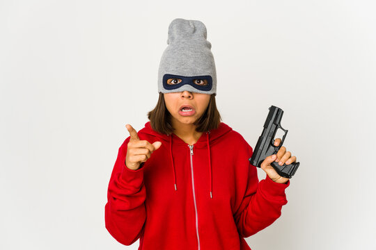 Young robber hispanic woman wearing a mask having an idea, inspiration concept.