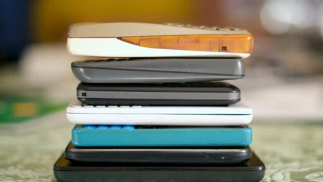 Pile of old unused mobile phones devices,electronic waste,technology concept