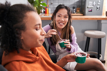 Girls chatting and talking about funny things, laughing on couch