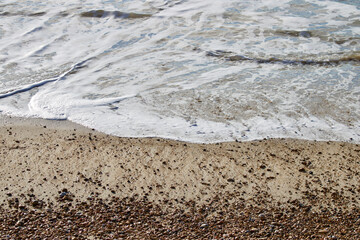 waves on pebble beach in british seaside resort