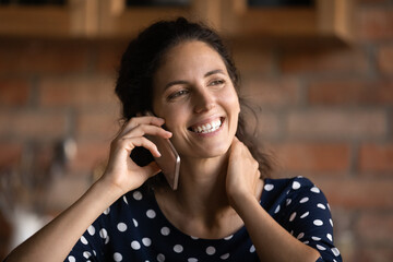 Close up of smiling millennial Caucasian female user have pleasant cellphone call on modern gadget....