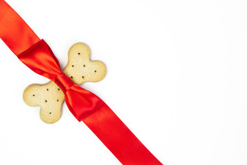 Diet   food  bone for dog puppy,  with red  ribbbon bow  on white background .Valentines day   and...
