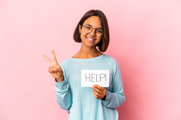 Fototapeta na wymiar Young hispanic mixed race woman holding a help poster showing number two with fingers.