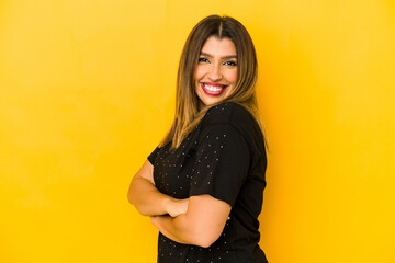 Young indian woman isolated on yellow background happy, smiling and cheerful.