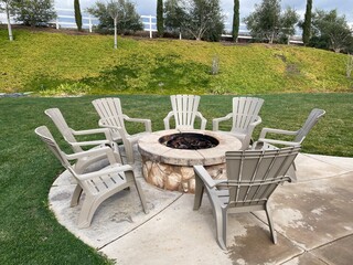 lounge chairs around the patio firepit to entertain guests