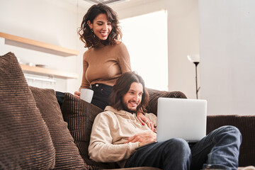 Married couple spending holiday time with laptop