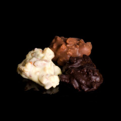 Handmade chocolate bonbons from belgian chocolate isolated on black background.