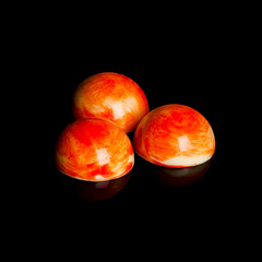 Handmade chocolate bonbons from belgian chocolate isolated on black background.