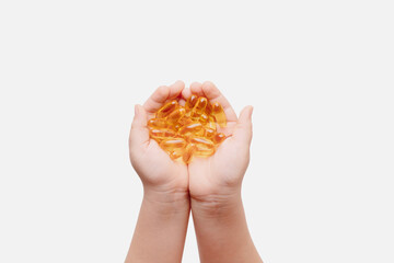 Close up of capsules Omega 3 in hands on white background. Top view, high resolution product. Health care concept