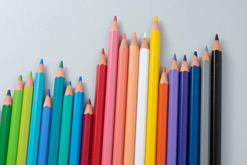 Colorful pencils in the case isolated on the gray background.