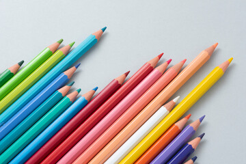 Colorful pencils in the case isolated on the gray background.