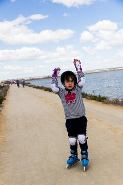 Child On Roller Skates On A Seaside Promenade