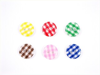 Colorful plastic sewing buttons isolated on white background
