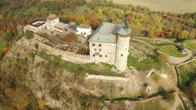 Picturesque autumn landscape with imposing historic Kuneticka Hora Castle on hilltop above Czech village of Raby, Pardubice Region