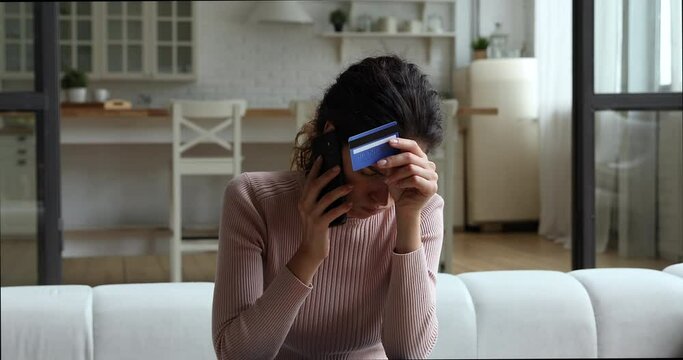 Stressed unhappy young woman holding conversation with bank operator or manager, feeling dissatisfied with e-banking service or having problems with credit card security, client complaints concept.