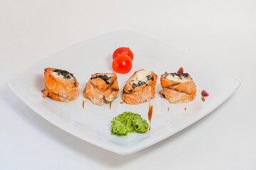 Sushi from red fish and seaweed. on white plate.