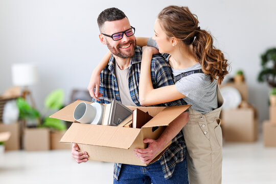 happy young married couple moves to new apartment