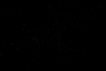 Obraz premium Random flying fire sparks particles isolated on the black background