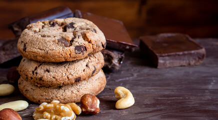 Organic food snack tasty sweet dessert milk dark chocolate chip salt cookie closeup piece fruit orange raspberry hazelnut nuts cinnamon on cocoa cacao powder wooden table for new year Christmas gift