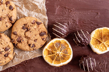 dark chocolate chip cookie round gold concept Organic fresh bake homemade tasty sweet dessert piece of closeup on cookie on wooden table for holiday new year Christmas gift sugar sparkle