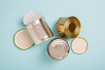 Separate collection of metal garbage. Iron stuff for recycle on blue background. Eco friendly concept. Recyclable metal waste on blue: tin cans and steel covers. Zero waste concept. Save the planet